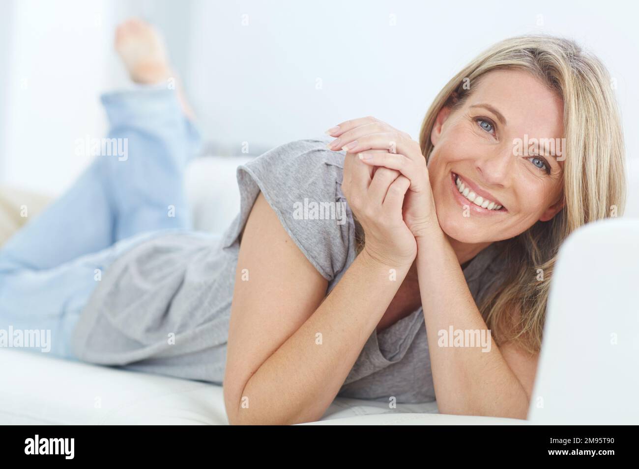 Mature woman lying on couch hi-res stock photography and images - Alamy