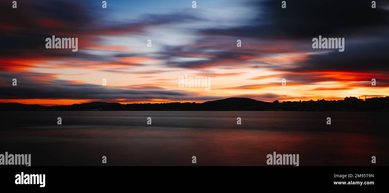 A breathtaking view of the red sunset over the sea Stock Photo - Alamy