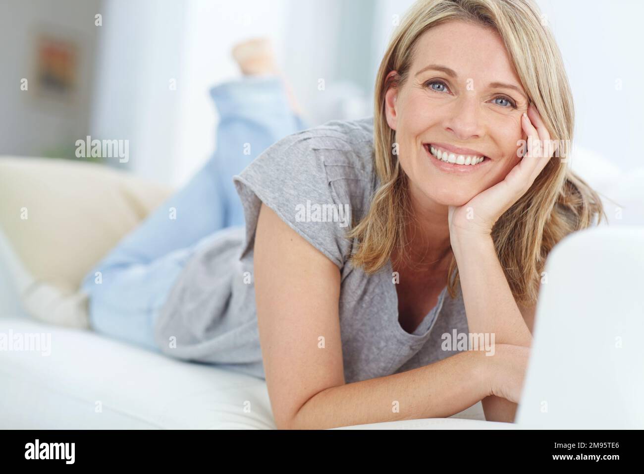 Mature woman lying on couch hi-res stock photography and images - Alamy