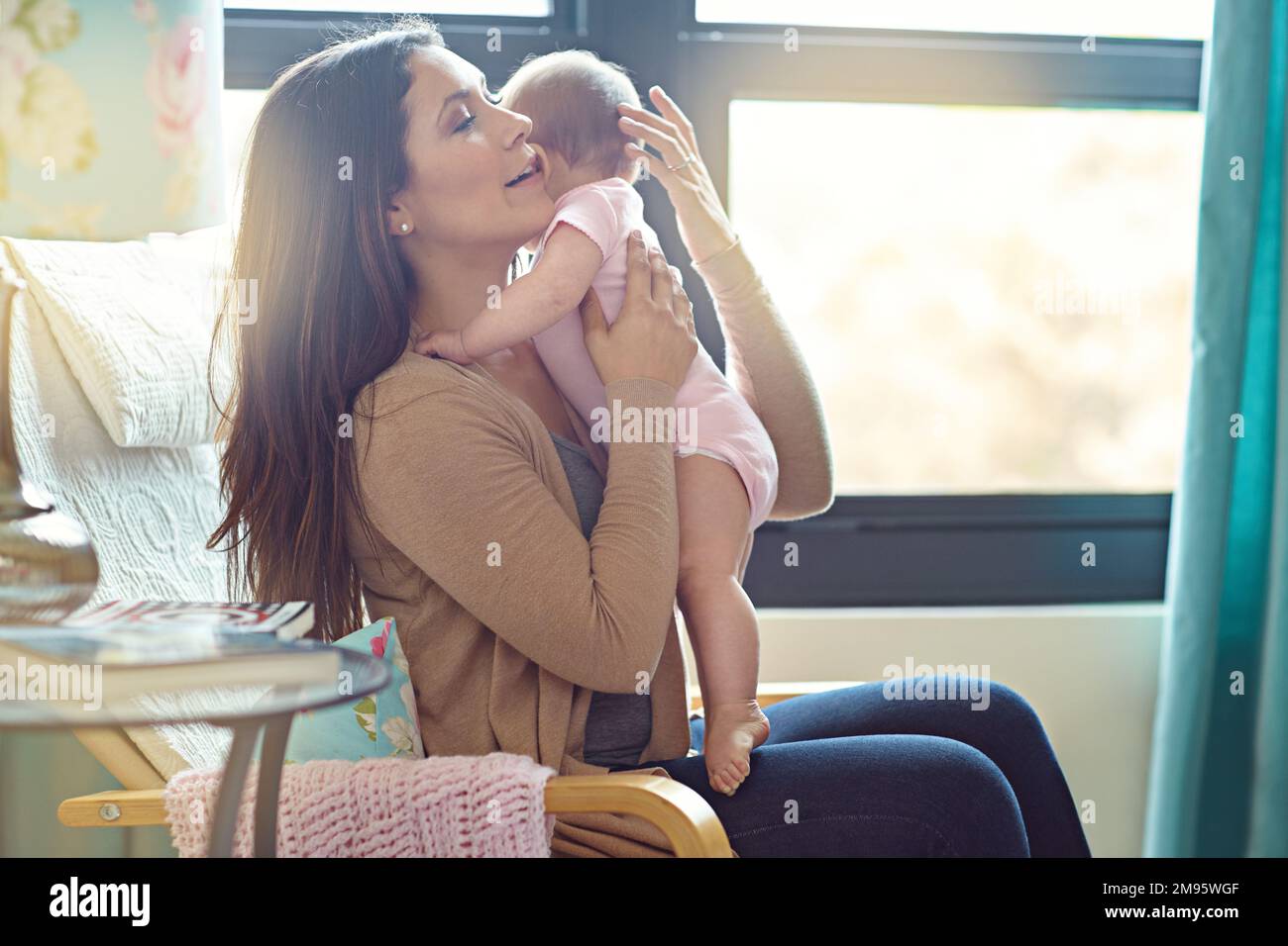 Mother, bonding or hugging baby girl in house living room or family home nursery in support trust, love or security. Mom, infant or child embrace in Stock Photo