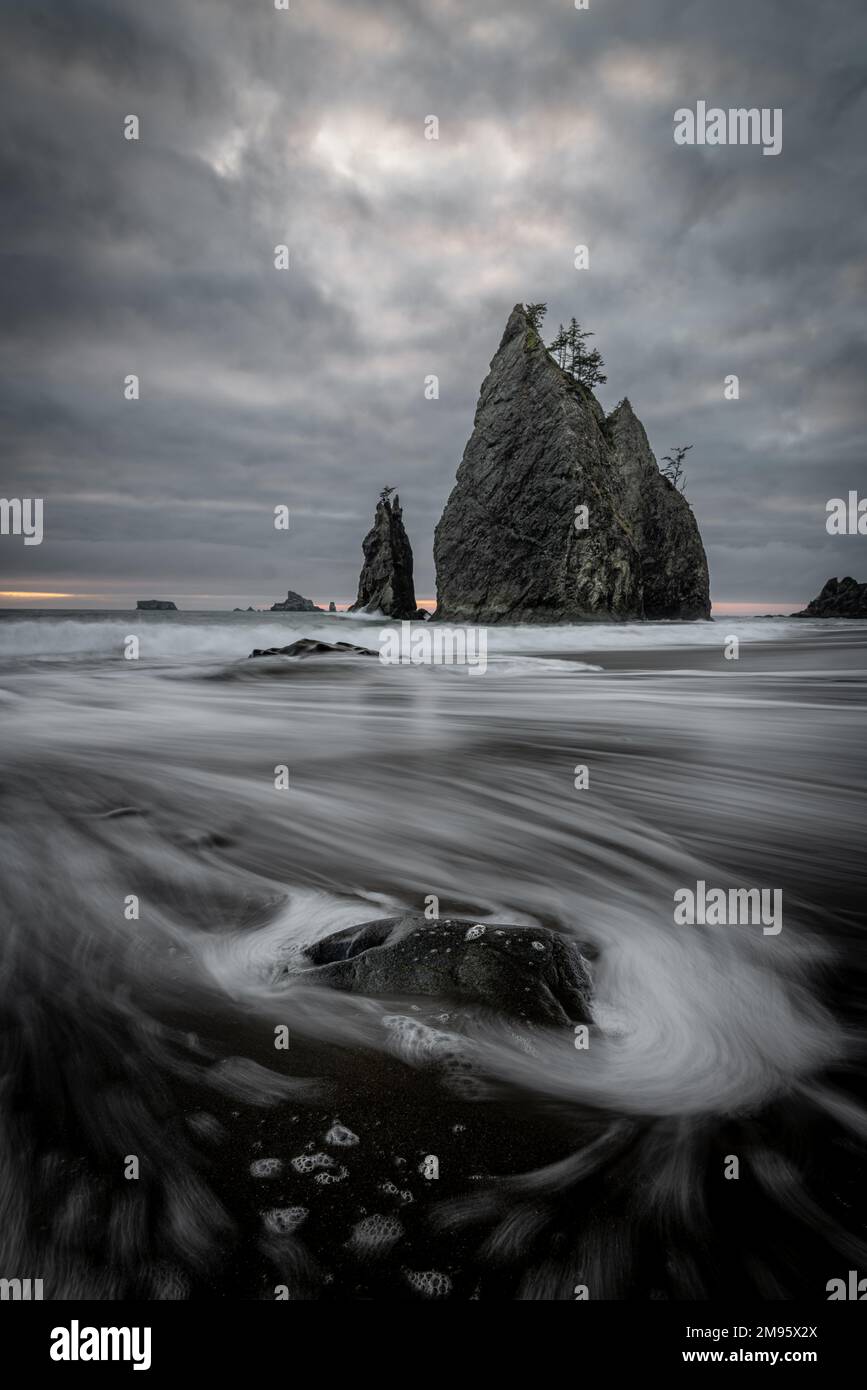 A vertical shot of the cliffs at Rialto Beach on a cloudy day. Olympic ...