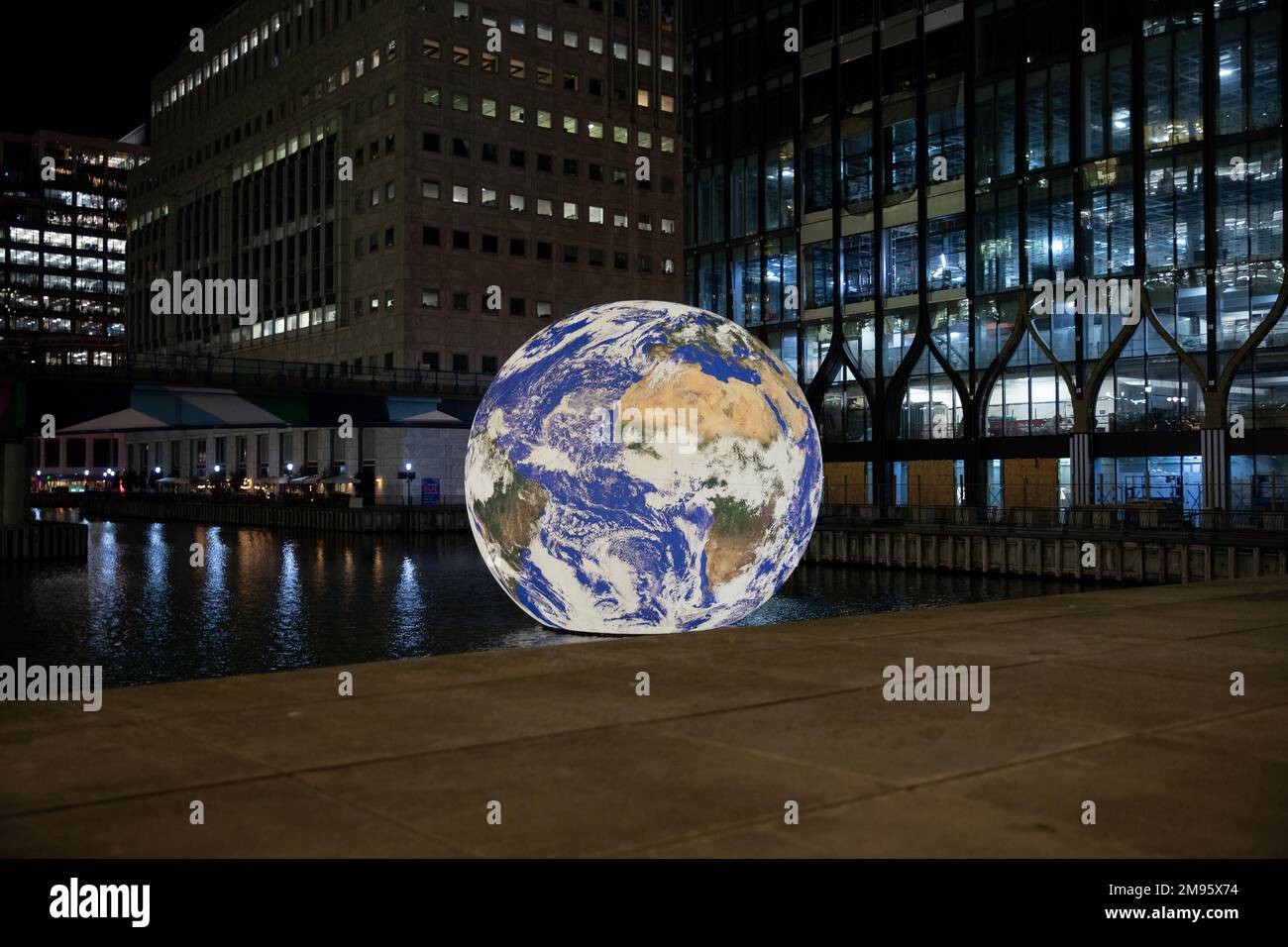 CANARY WHARF, LONDON, 16th JANUARY 2023, Floating Earth is an installation by artist Luke Jerram and currently being displayed as a part of Canary Wharf's Winter Lights Festival. Credit: Lucy North/Alamy Live News Stock Photo