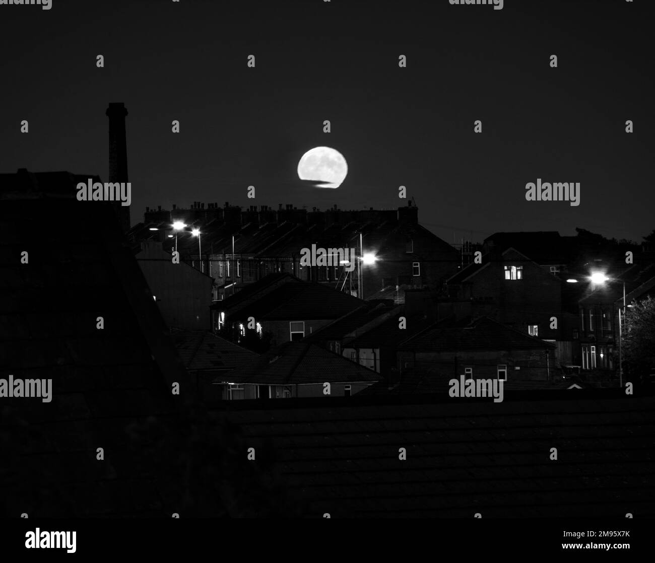 A grayscale of the house buildings of the village of Queensbury and the