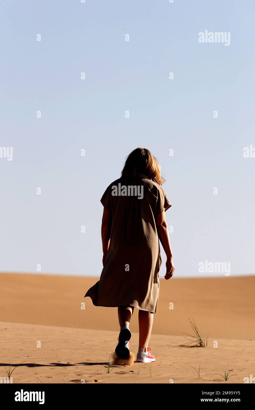 Woman walking alone on hi-res stock photography and images - Alamy
