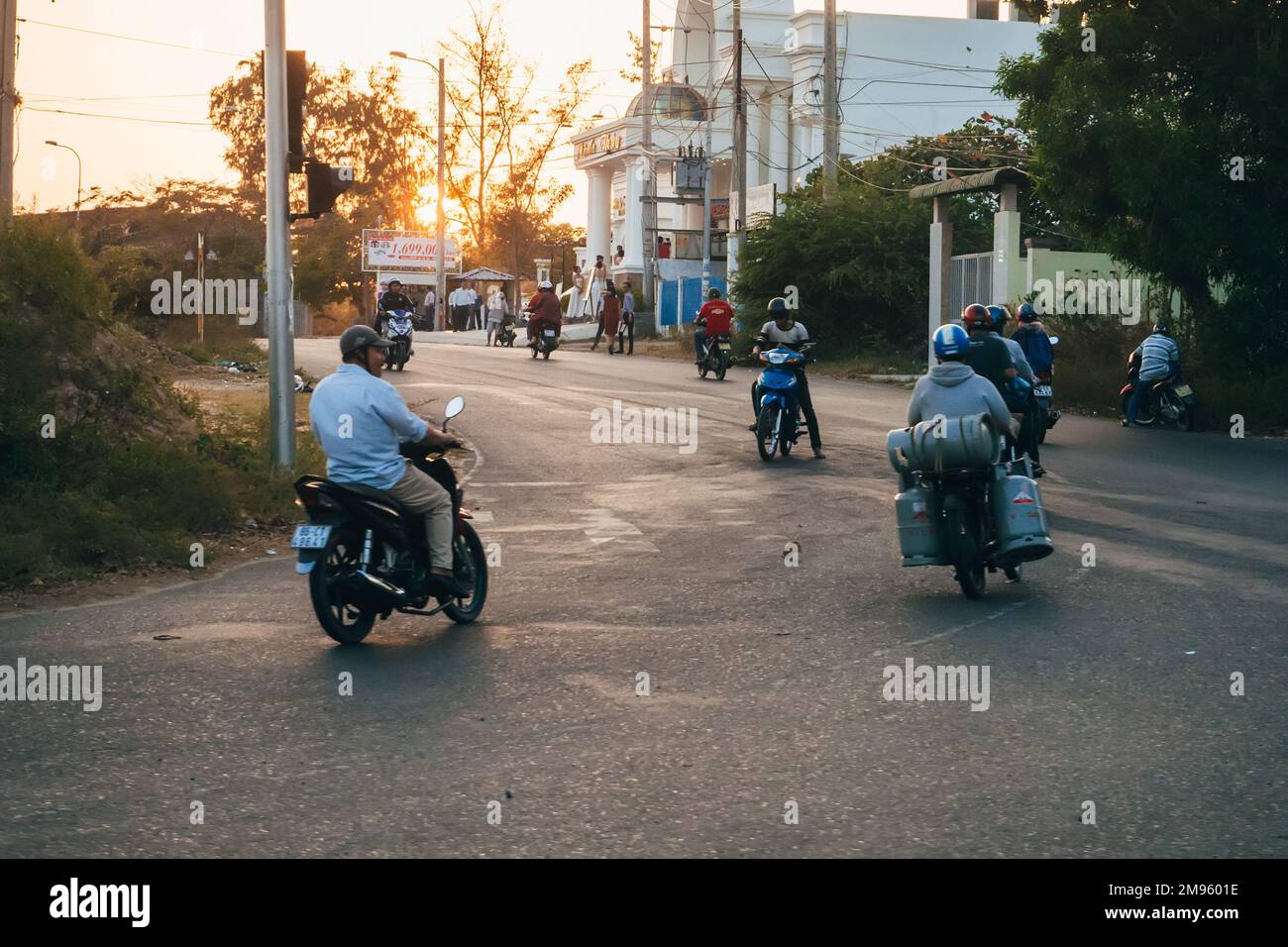MUI NE, VIETNAM - CIRCA MARCH 2017: A lot of people riding motorbikes on the road Stock Photo