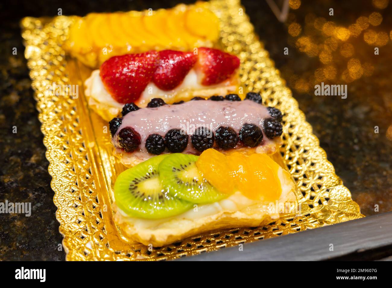 Delicious fresh baked colorful decorated cakes, tarts with cream and ...