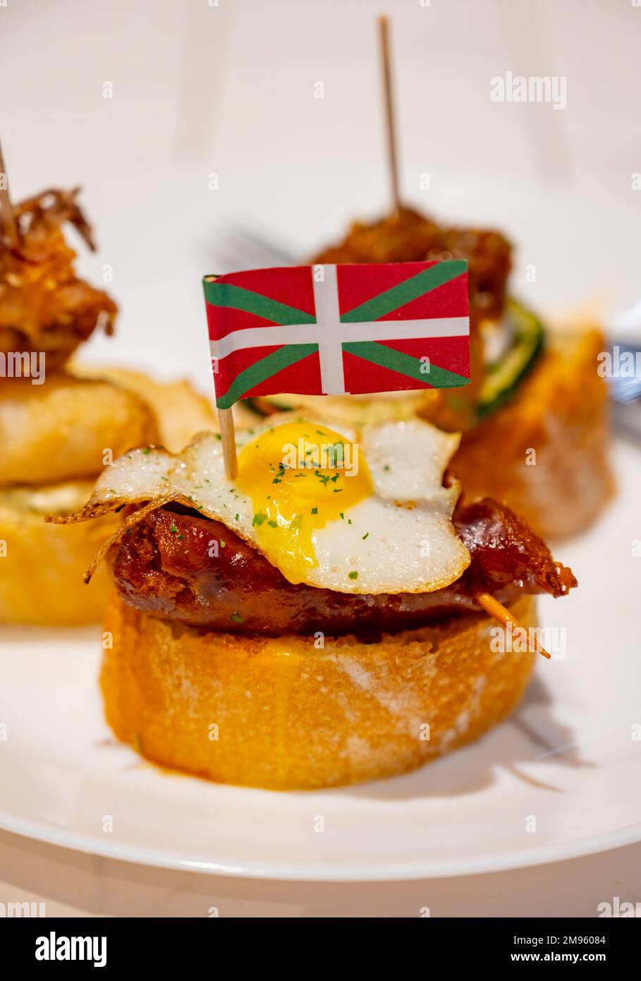 White board with typical snack and flag of Basque Country, pinchos or ...