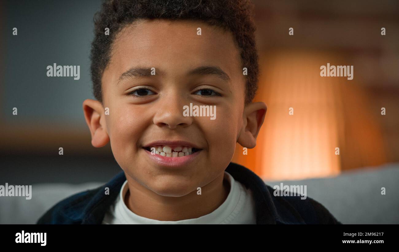 Close up head shot portrait indoors child boy ethnic male kid African American smiling happy little small son schoolboy preschooler smile toothy Stock Photo