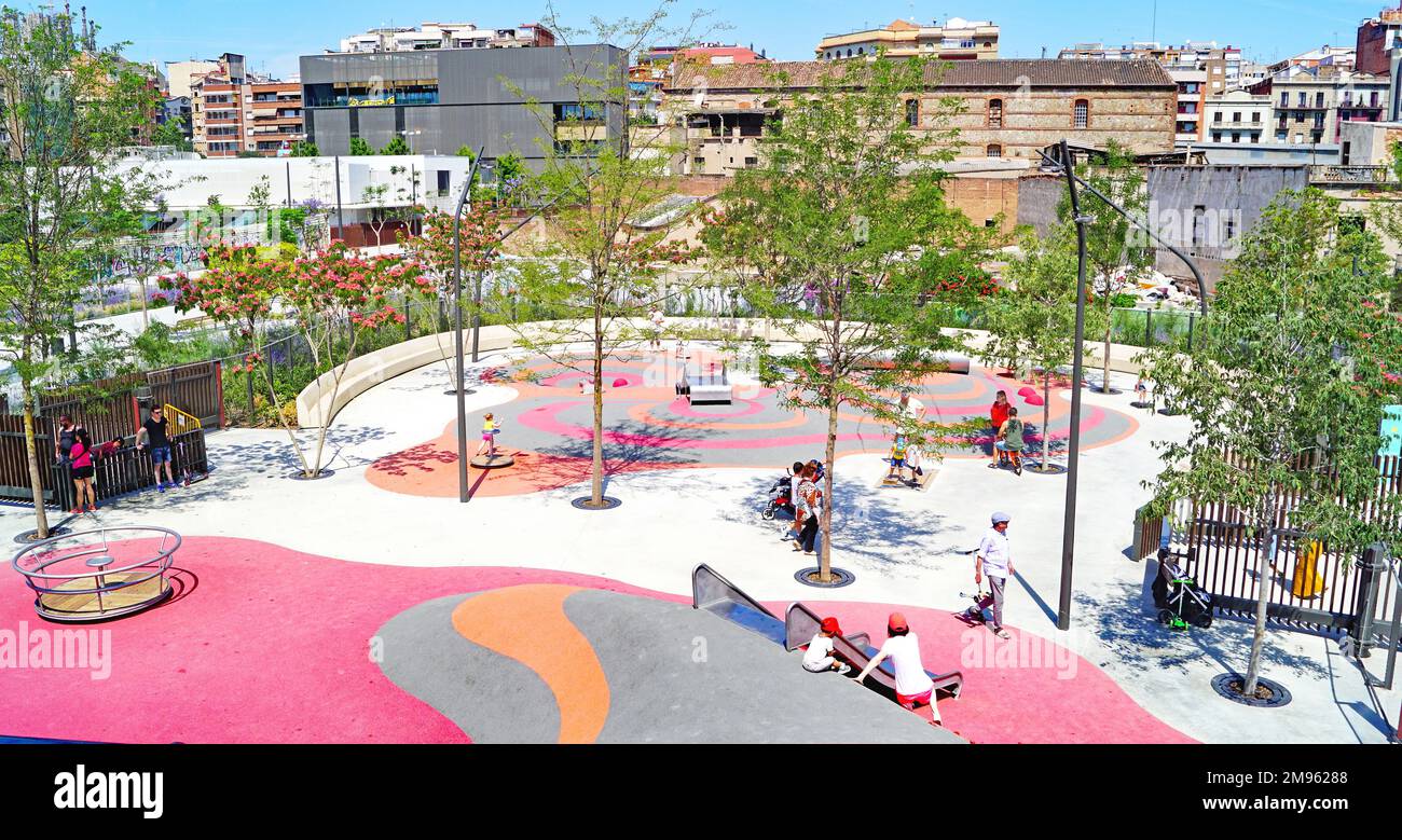 slides and swings in a playground in a neighborhood of Barcelona