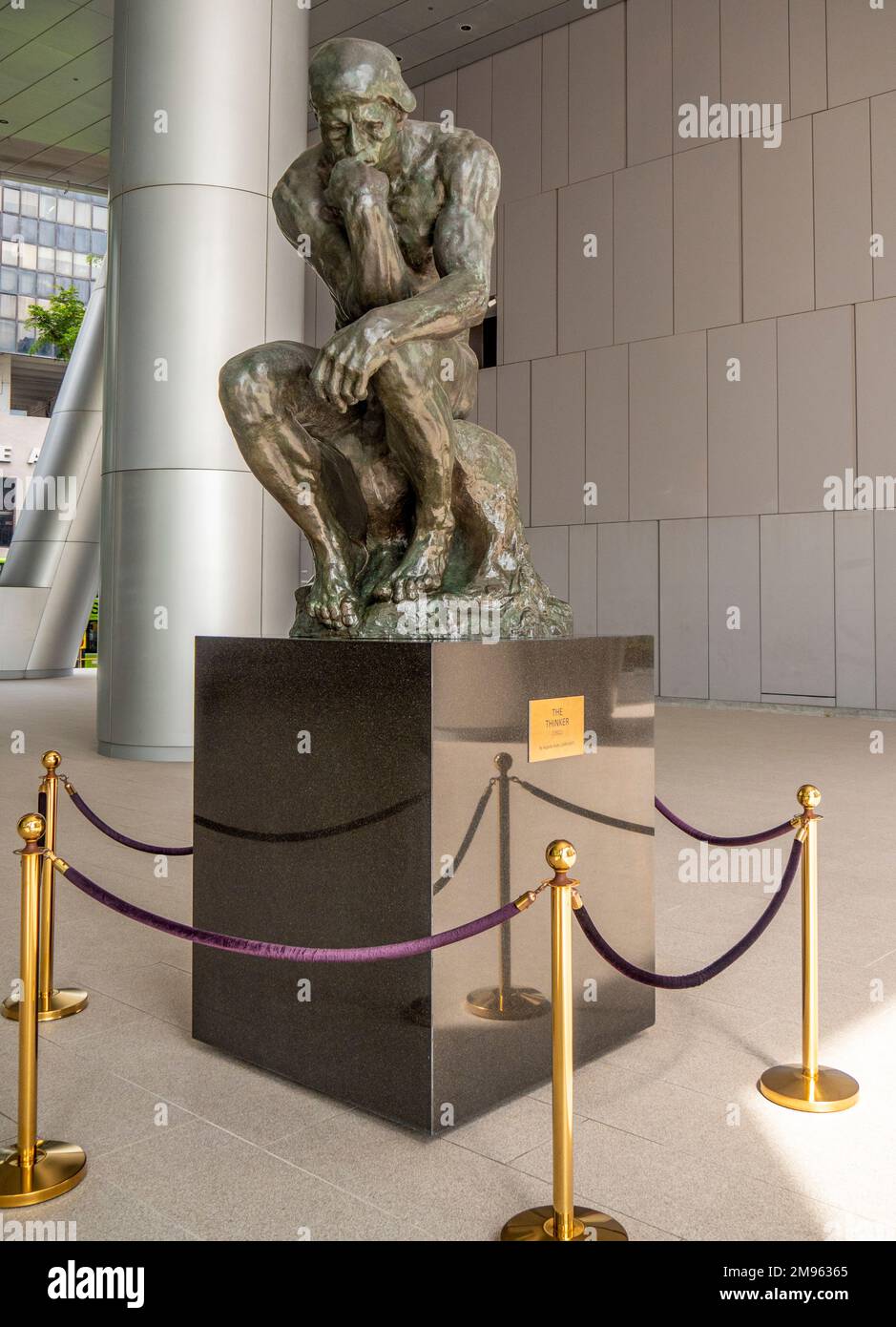 Bronze statue The Thinker by Auguste Rodin on public display in undercroft of OUE Bayfront Building in CBD or Singapore Stock Photo