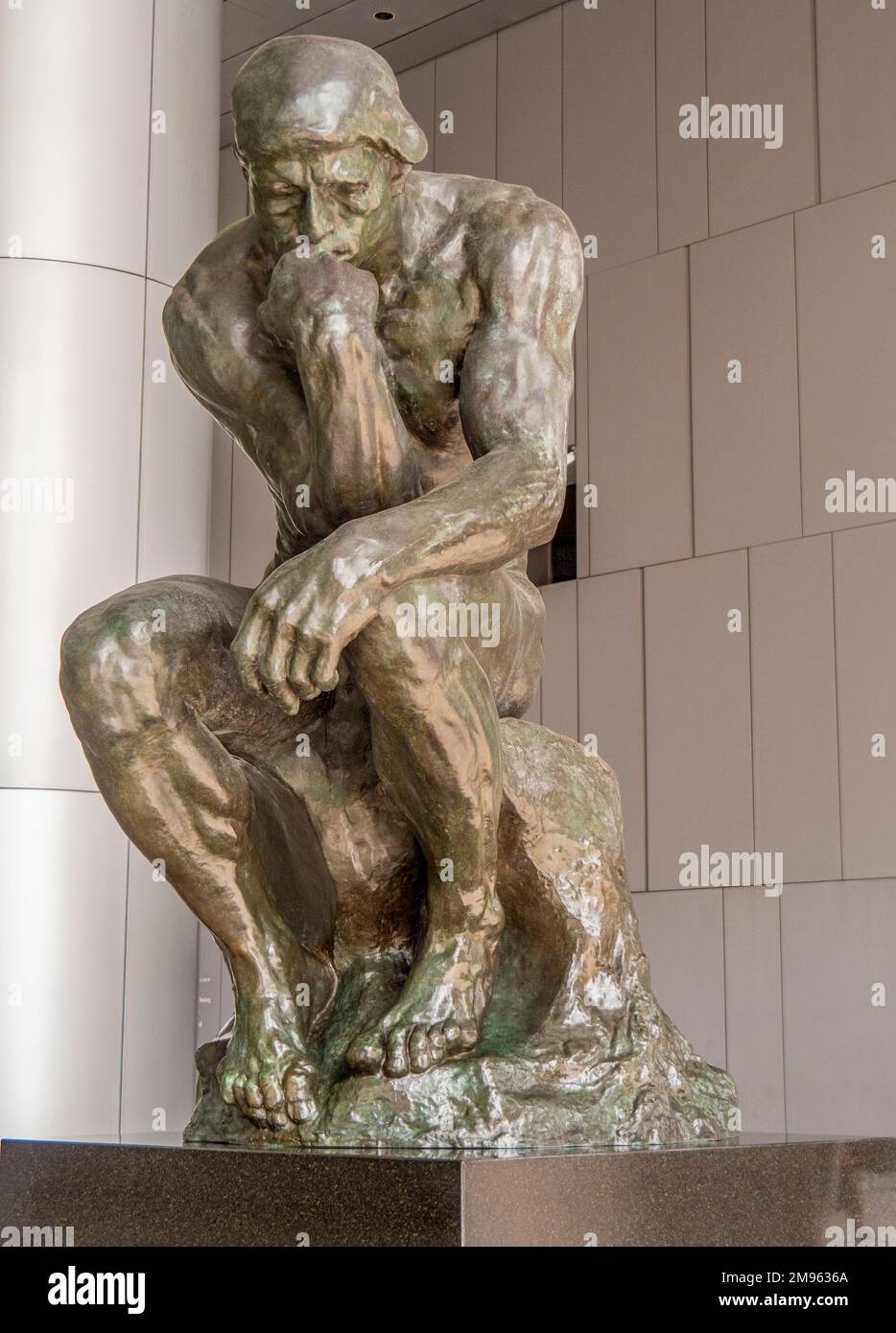 Bronze statue The Thinker by Auguste Rodin on public display in undercroft of OUE Bayfront Building in CBD or Singapore Stock Photo