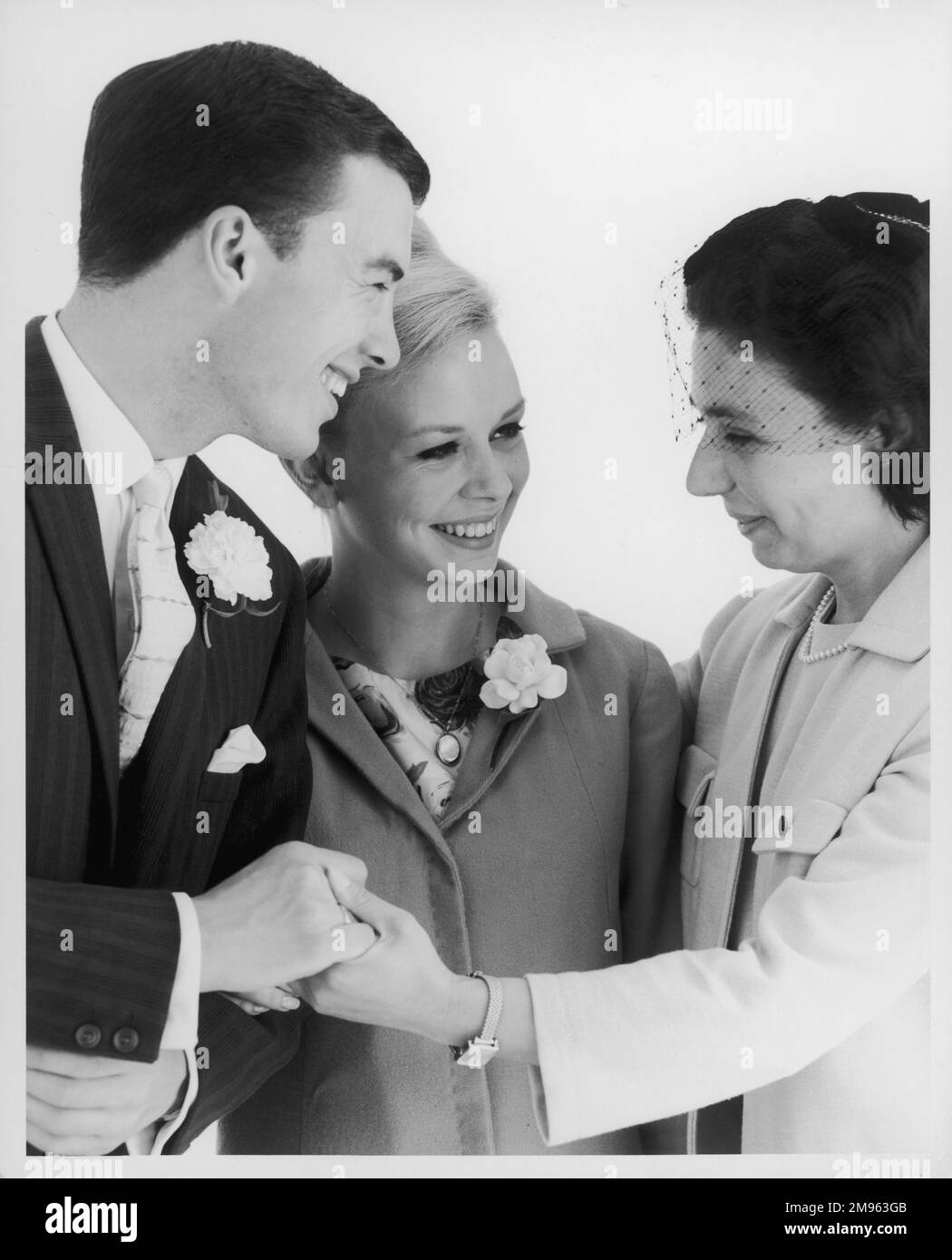 One of the wedding guests wishes the newlyweds well as they prepare to depart for their honeymoon. Stock Photo
