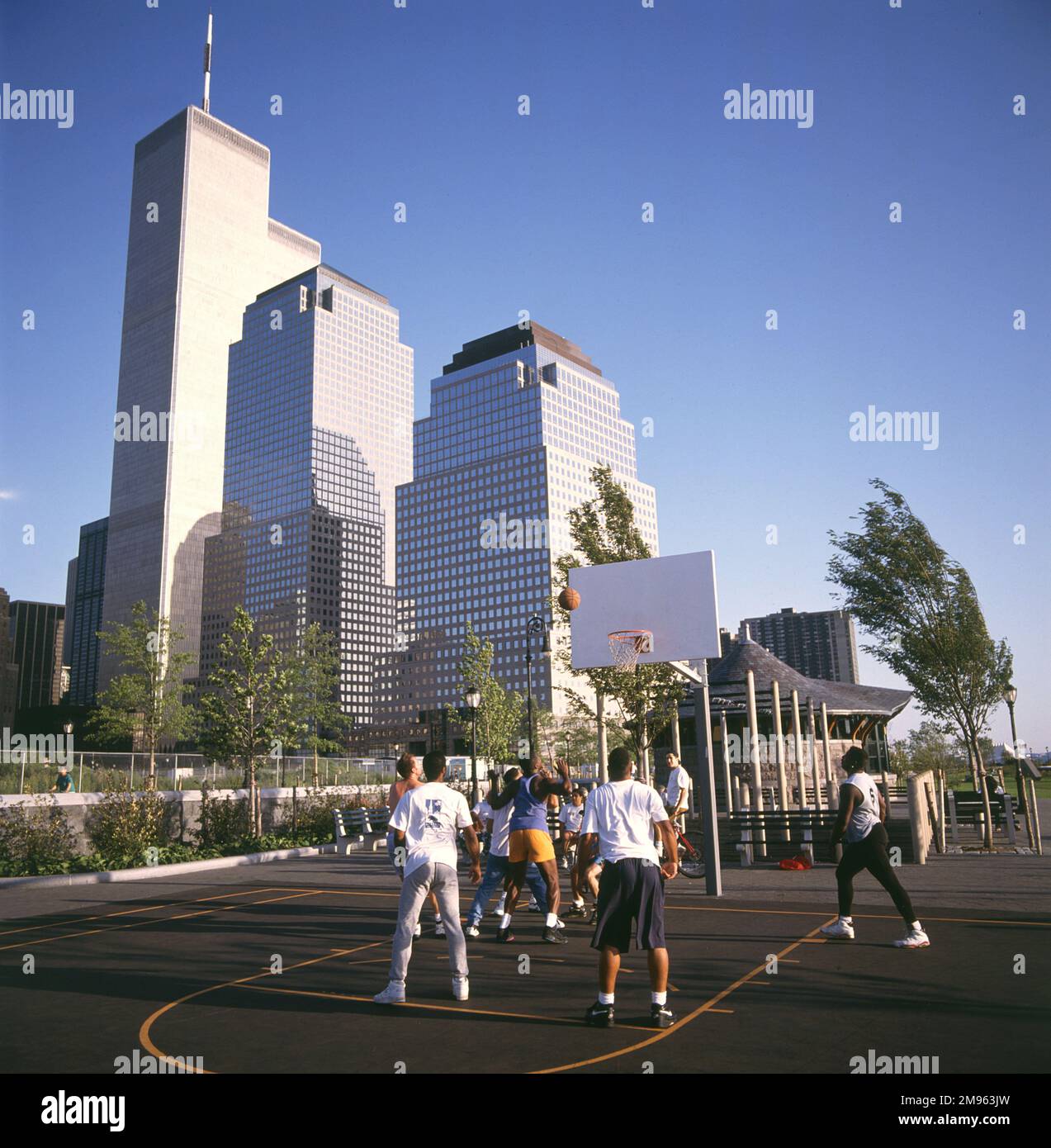 A basketball game taking place beneath skyscrapers, including the twin towers of the World Trade Center which were destroyed by terrorists on 11 September 2001. Stock Photo
