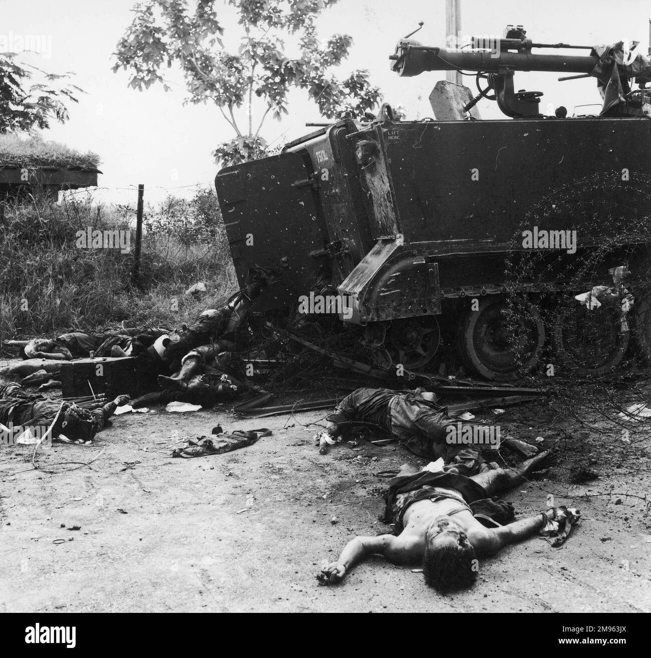 Phnom Penh: bodies lay strewn and piled up around a battered tank, after an assault by the Viet Cong Stock Photo