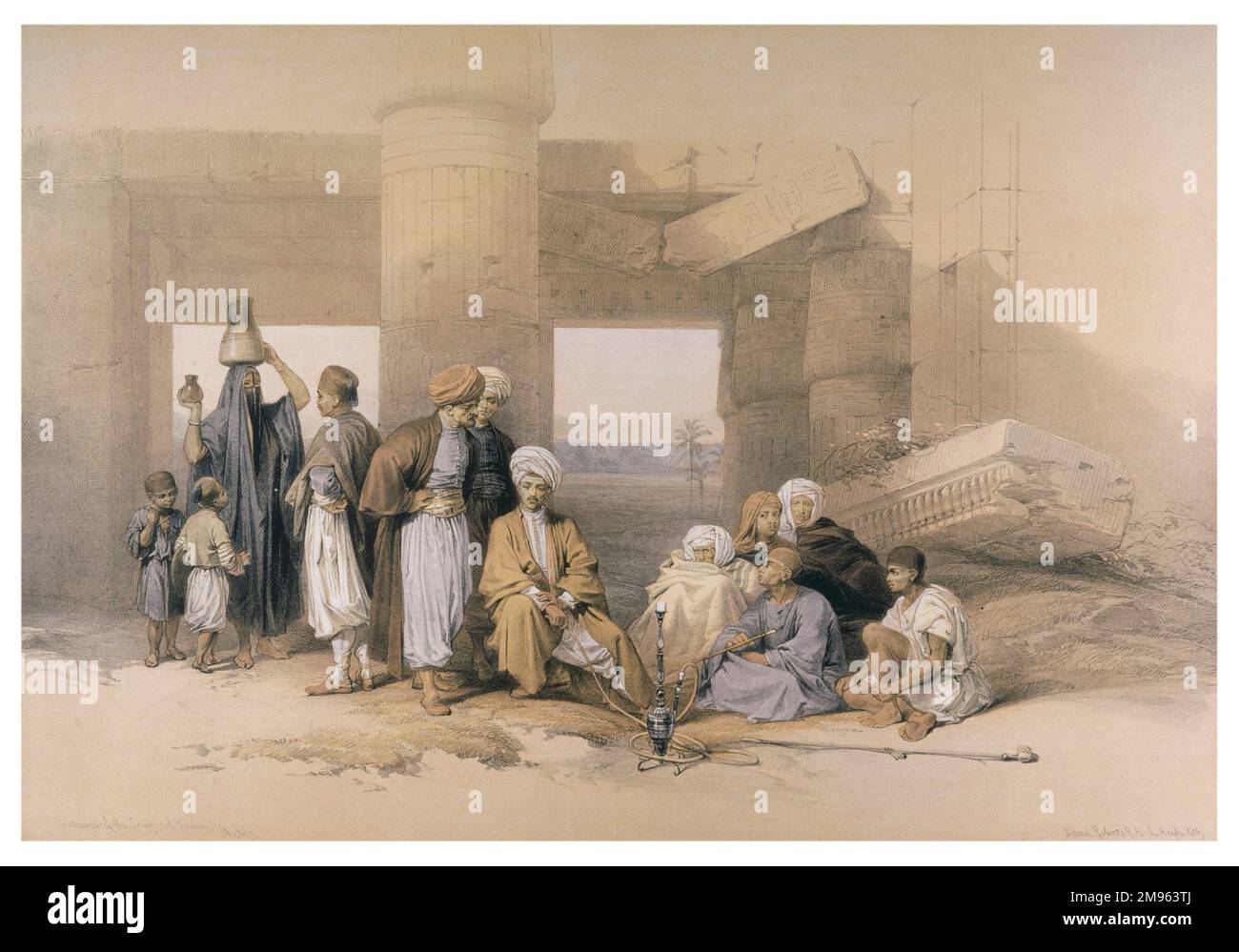 Local men women and children sit amid the fallen stones of the entrance to the Temple of Amun, Thebes. Stock Photo
