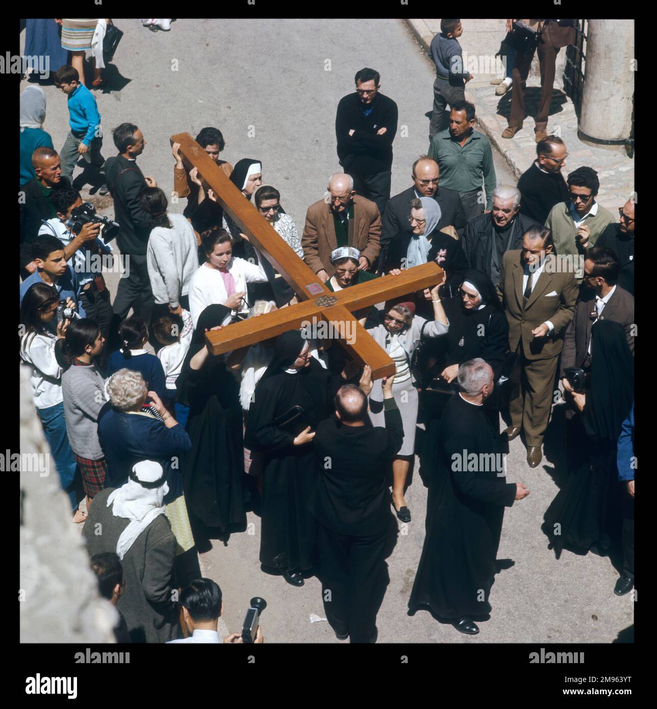 Aerial view of men, women and children in a Good Friday procession ...