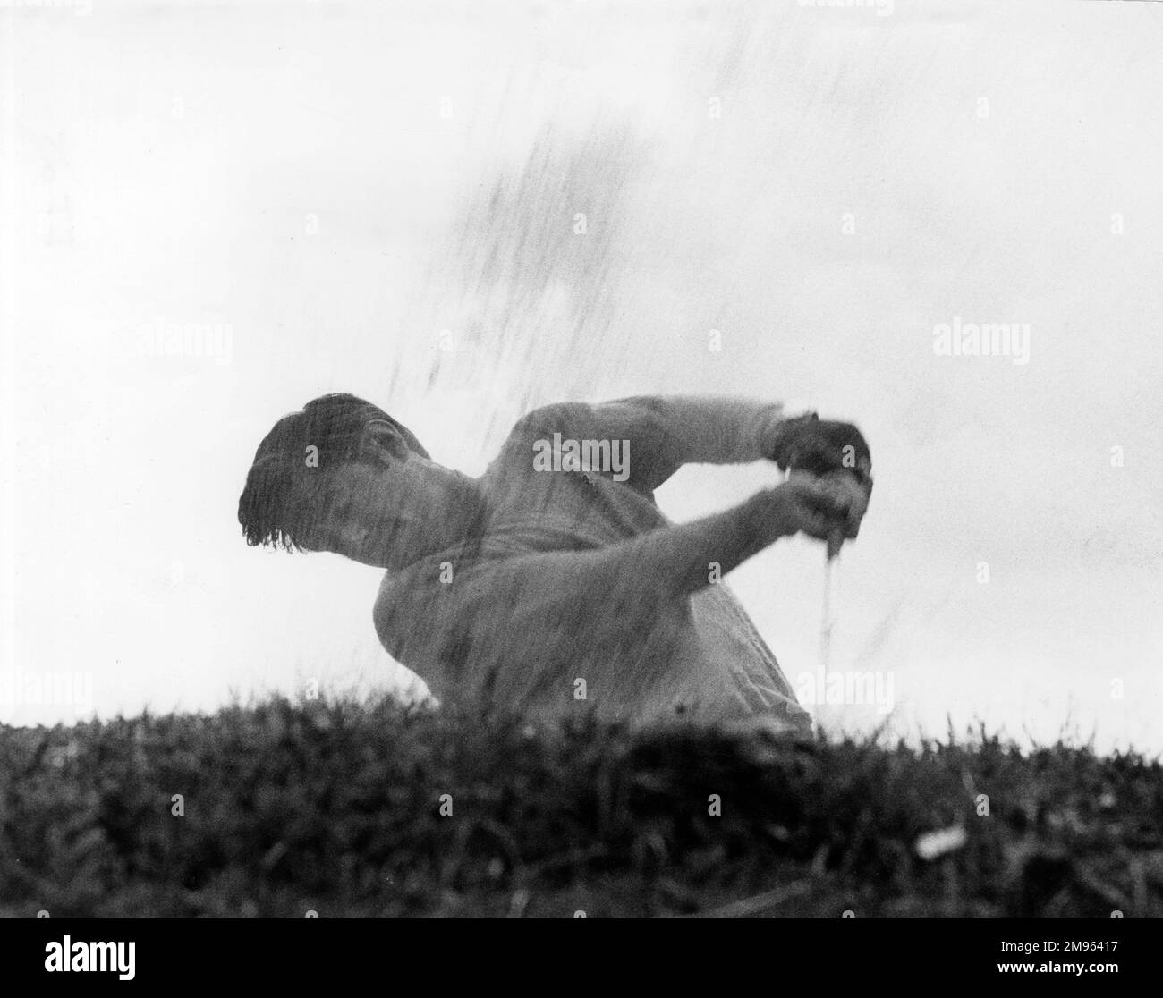 A golfer tries to get out of a bunker Stock Photo