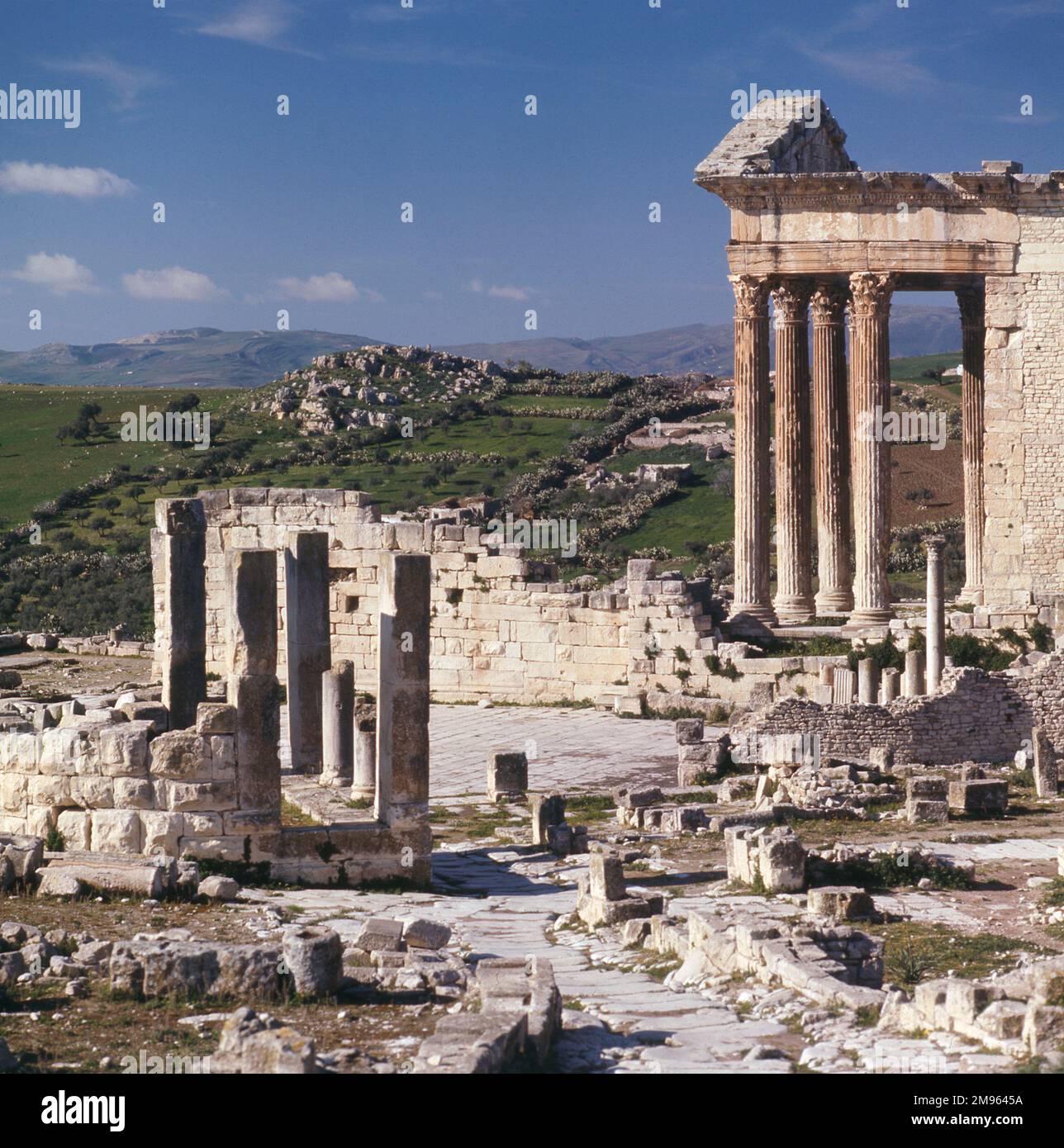 The remains of the Capitol building at Dougga, Tunisia. Dougga served as one of the capitals of Massinissa, a Roman ally, and one of the contenders to Carthage. Stock Photo