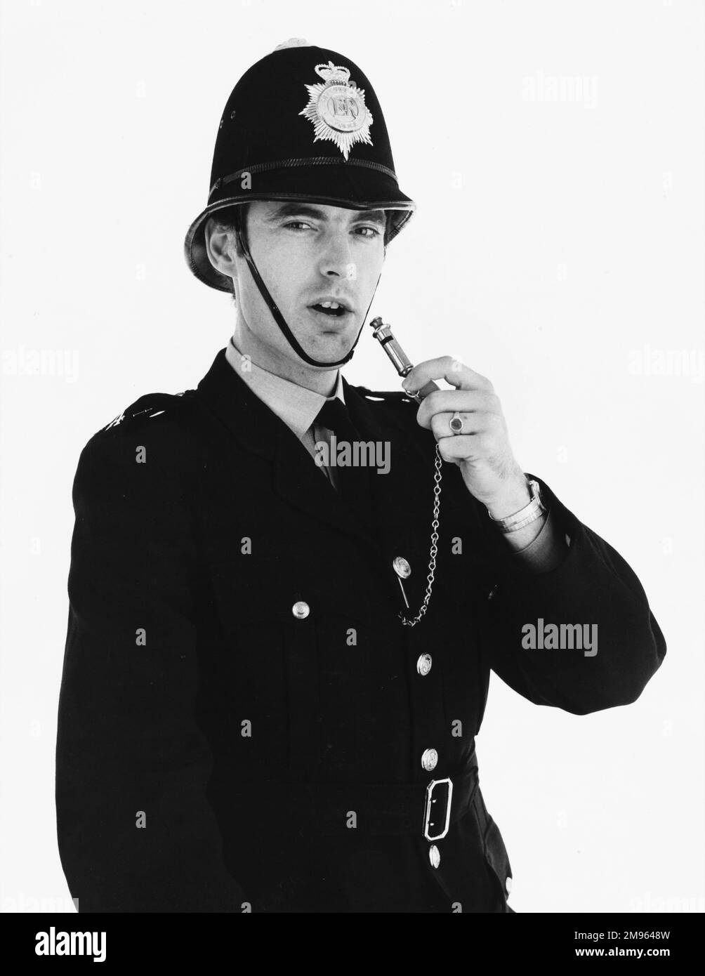 A policeman gets ready to blow his whistle. Stock Photo