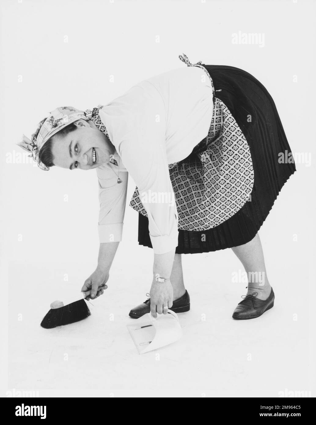 A stereotypical cleaner sweeping dust off the floor Stock Photo Alamy