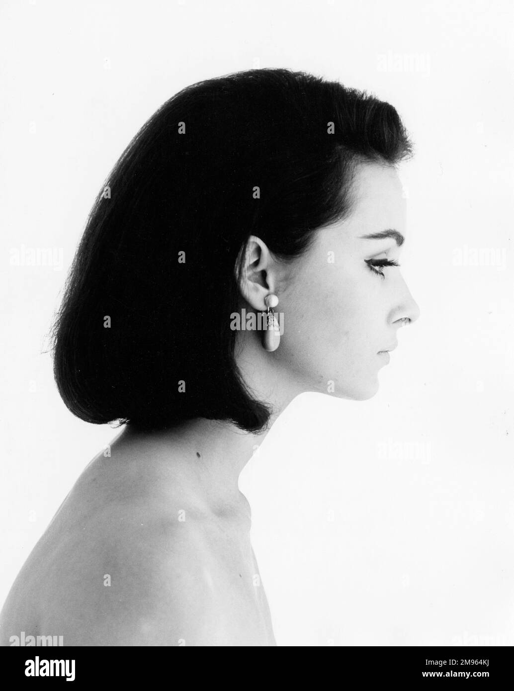 Head and shoulders profile of a dark haired woman. Stock Photo