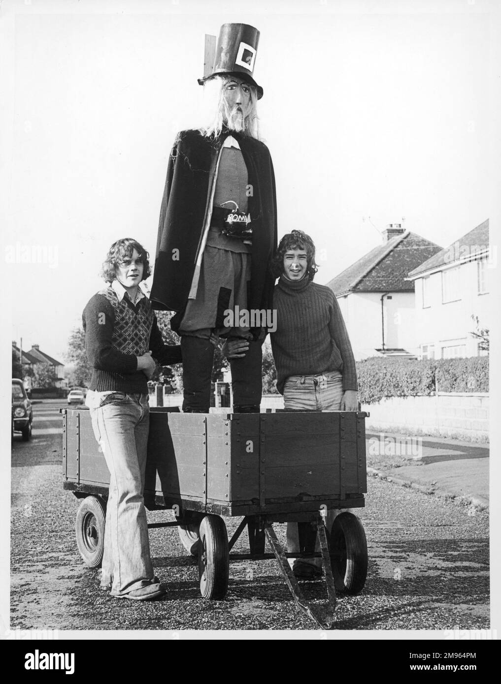 Penny for the Guy! Two teenage boys with a splendid home-made Guy Fawkes in a truck, with a 'bomb' strapped to his chest. Stock Photo