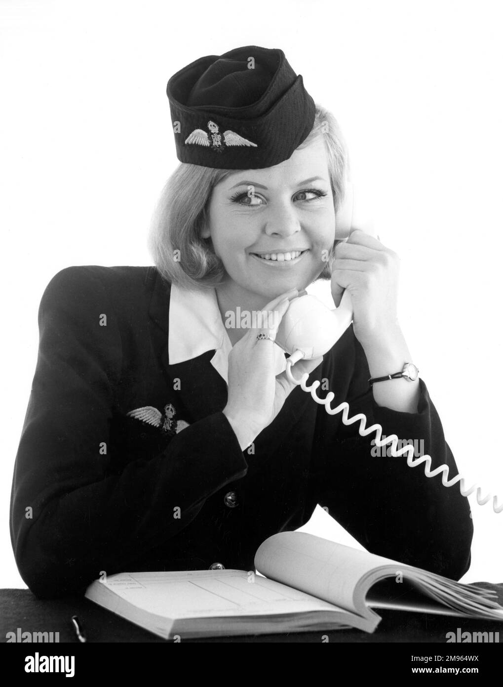 An air hostess talks on the phone. Stock Photo