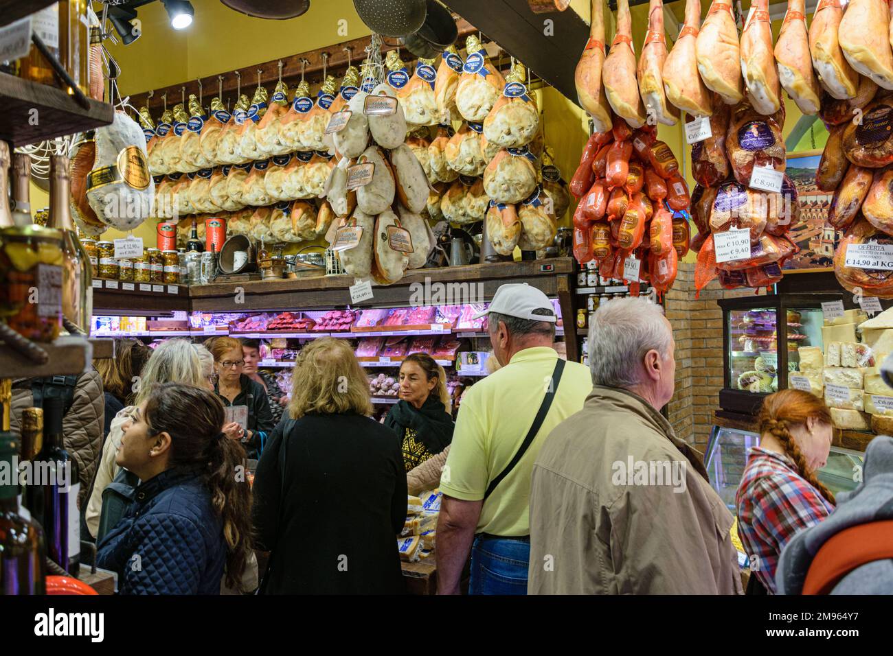 A delicatessen in Bologna. Cured hams hanging from ceiling Stock Photo Alamy
