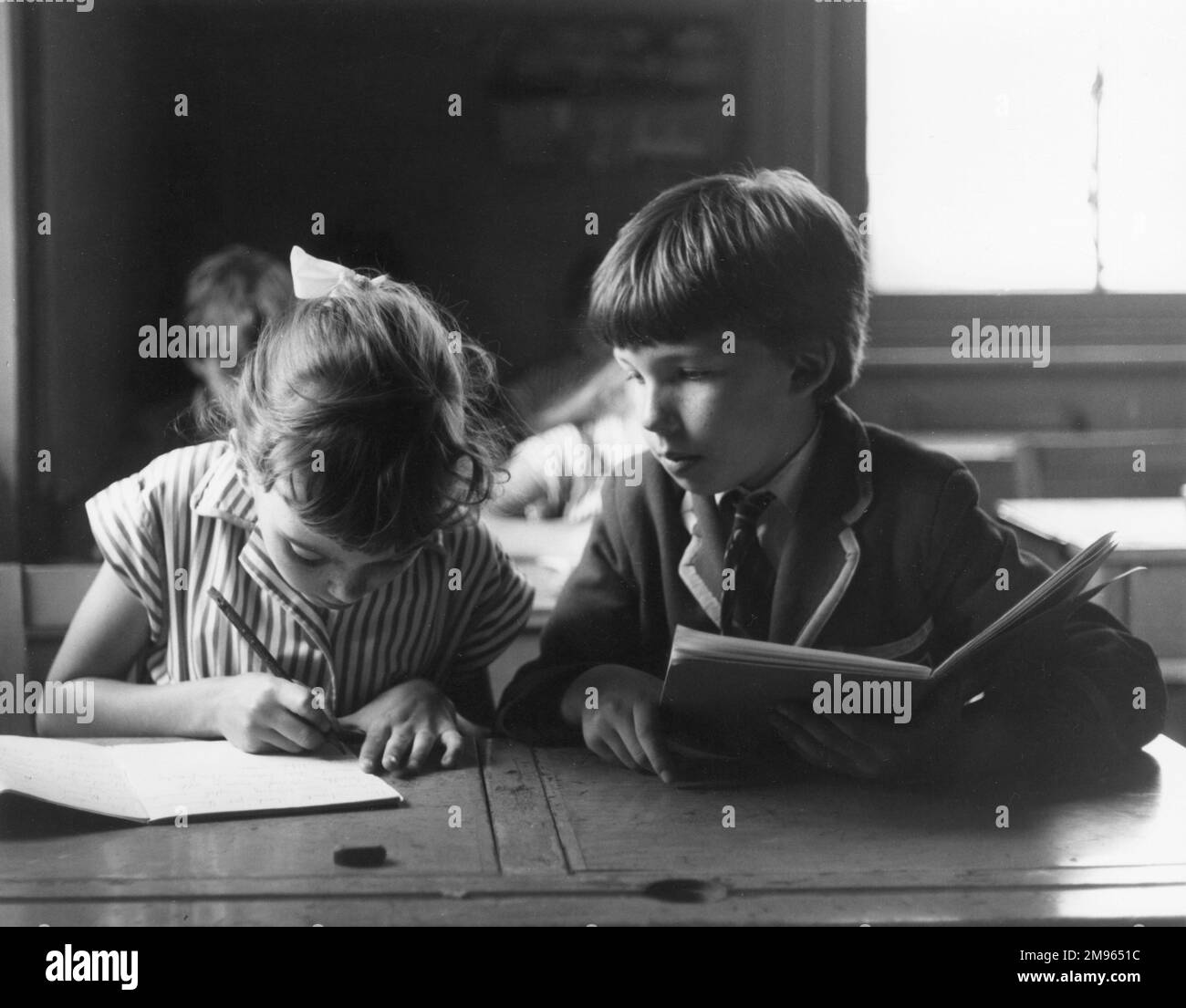 A schoolboy tries to copy his neighbour's work Stock Photo - Alamy