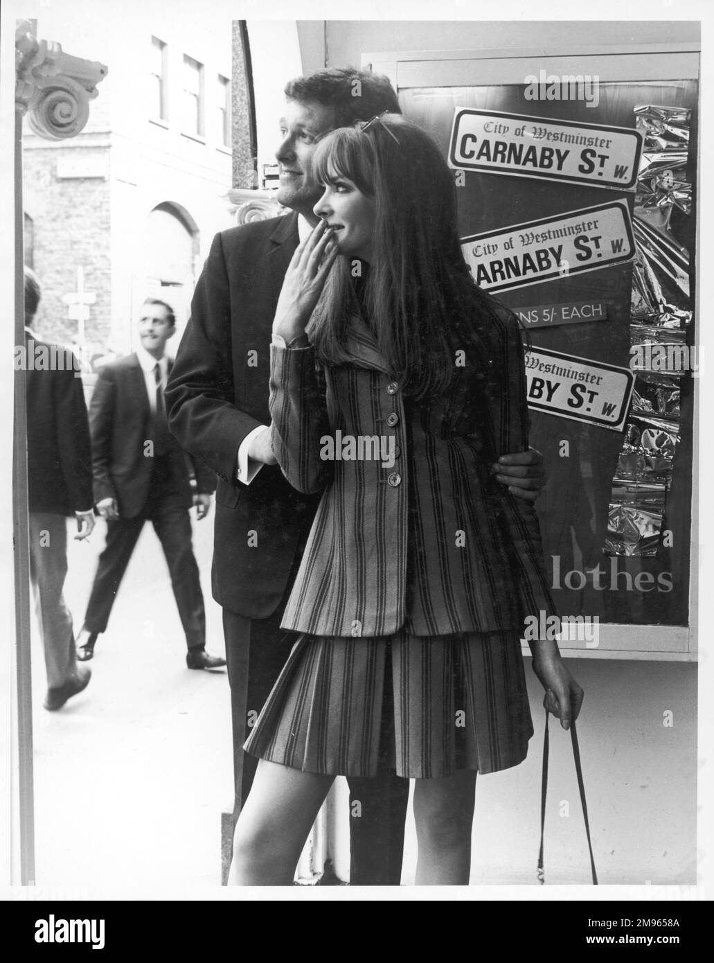 A suitably dressed couple shopping on Carnaby Street, the hip centre of swinging London. Stock Photo