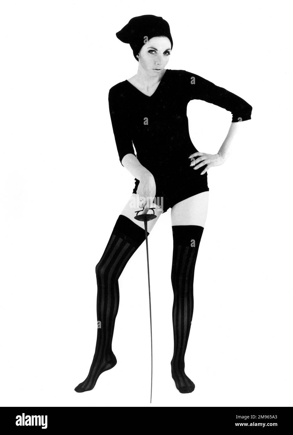 A woman poses in a leotard holding a fencing foil. Stock Photo