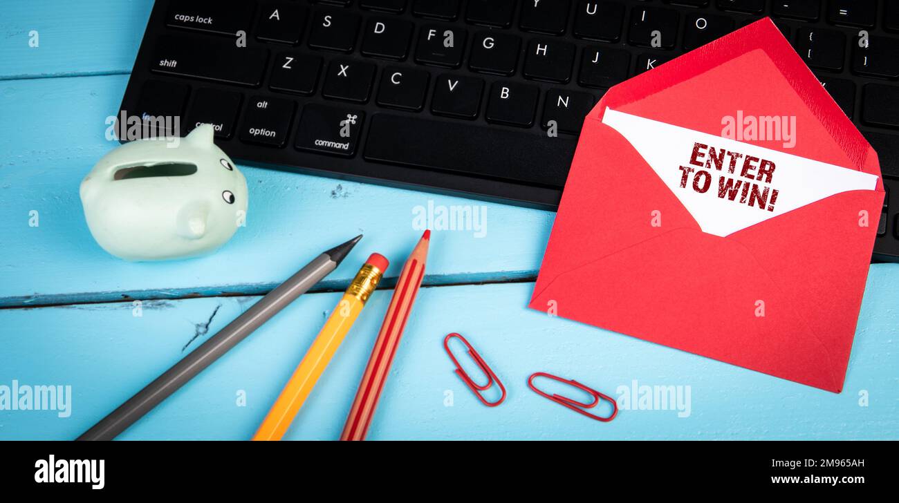 Enter to win. Computer keyboard on a blue office table. Stock Photo