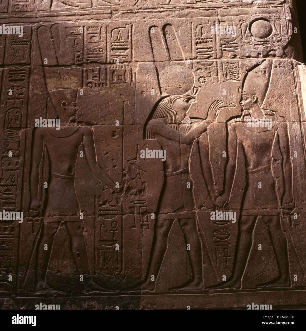 Wall relief in the inner sanctuary of the AMUN TEMPLE (TEMPLE OF LUXOR), depicting the god AMUN-RE (left), Horus (centre) and Alexander the Great (?), Luxor Egypt. Stock Photo