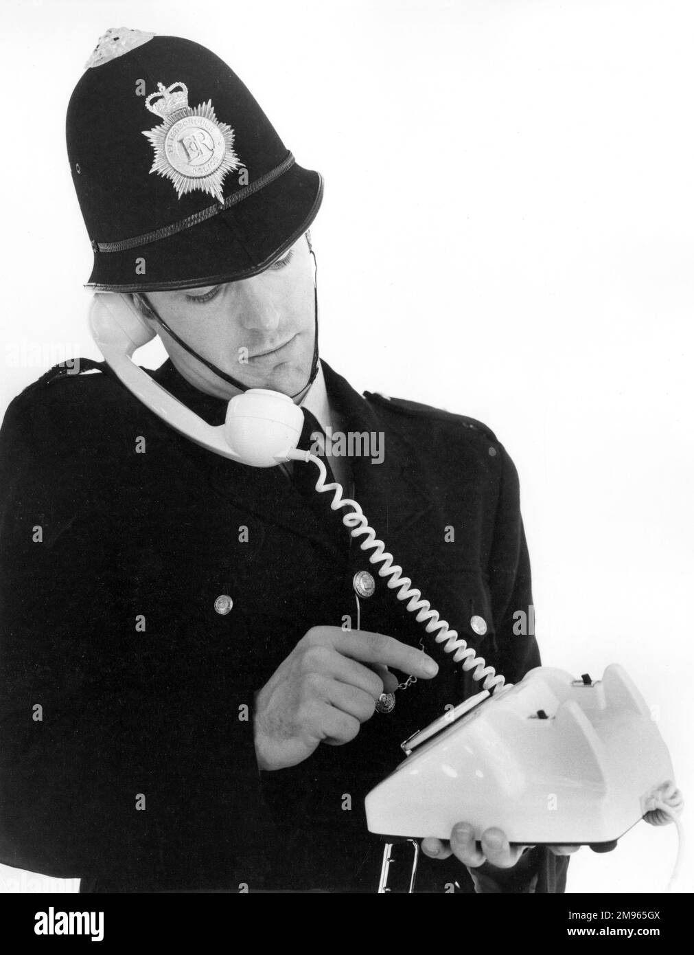 A young policeman makes a telephone call Stock Photo Alamy