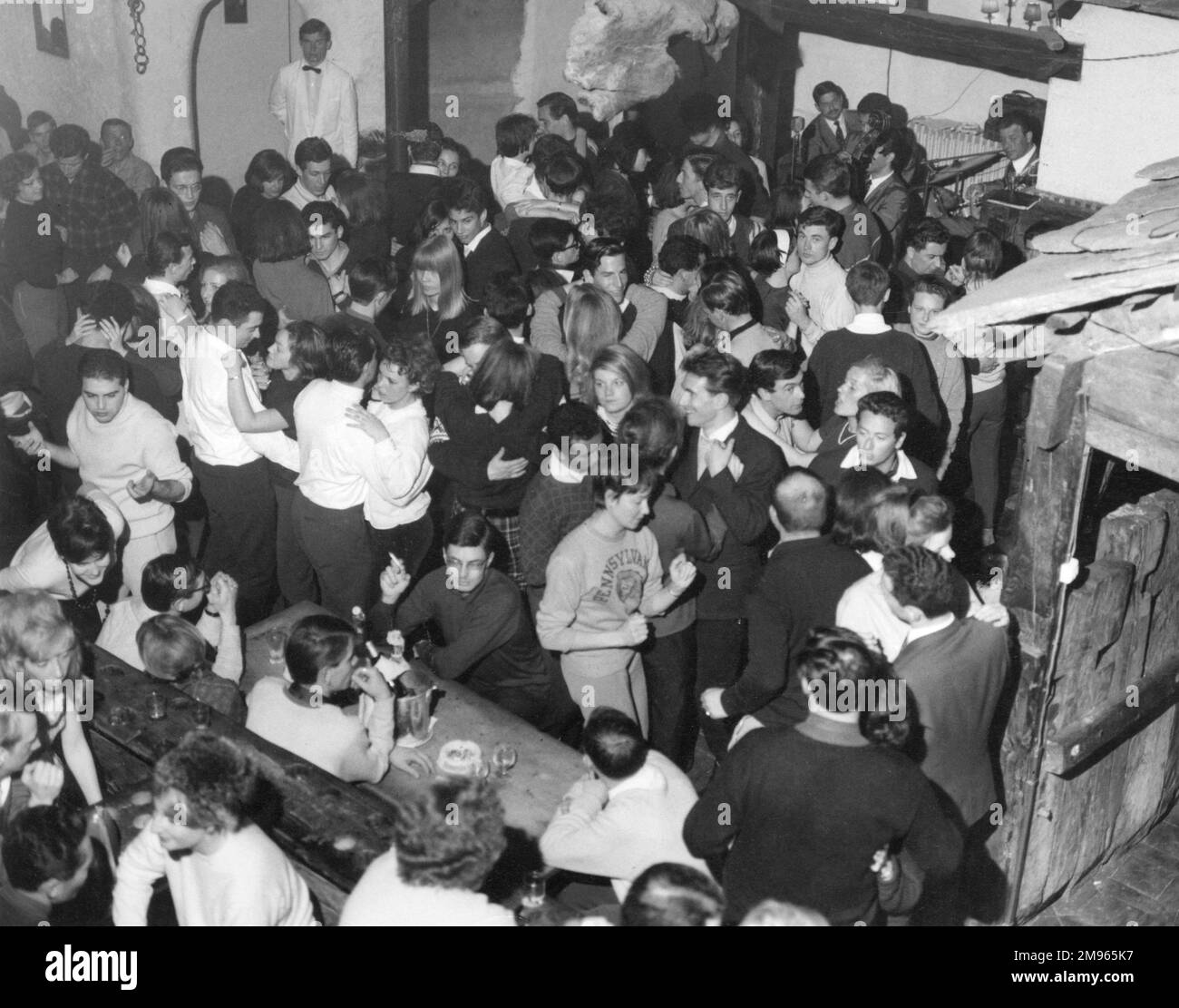 Young people letting their hair down at a discoteque. Stock Photo