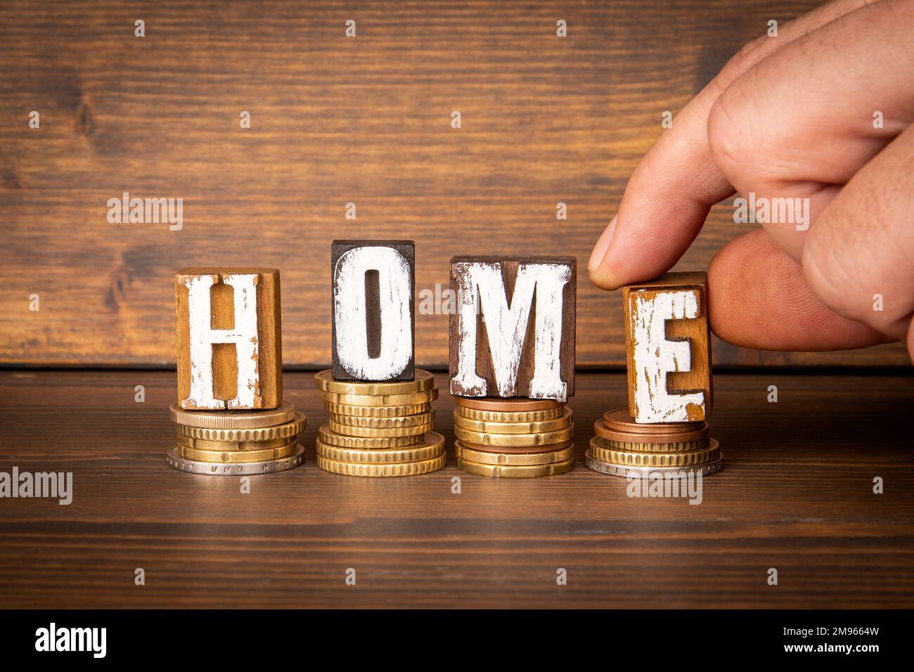 HOME. Expenditure and cost concept. Word from wooden blocks and money Stock Photo Alamy