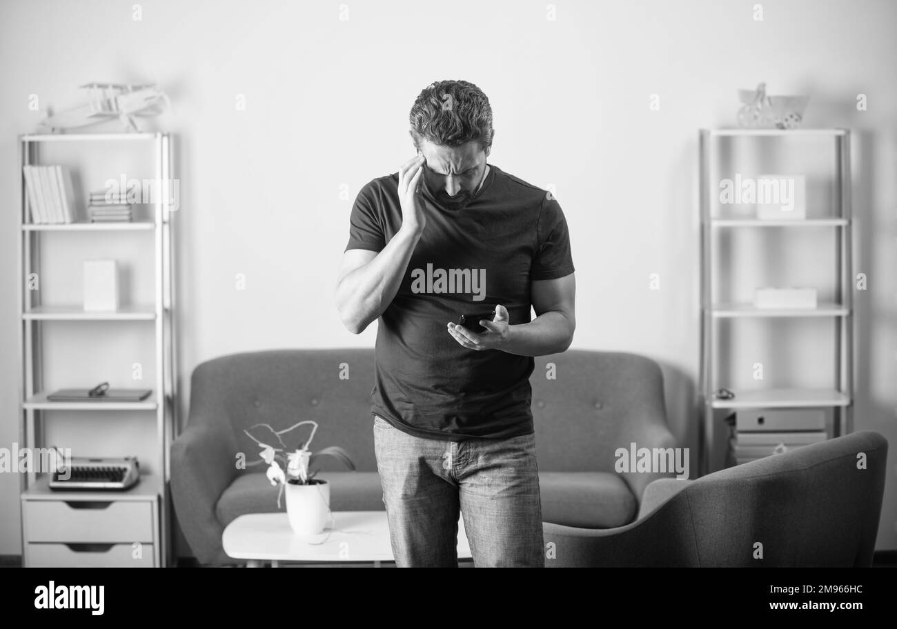 Unhappy adult man check Black and White Stock Photos & Images - Alamy