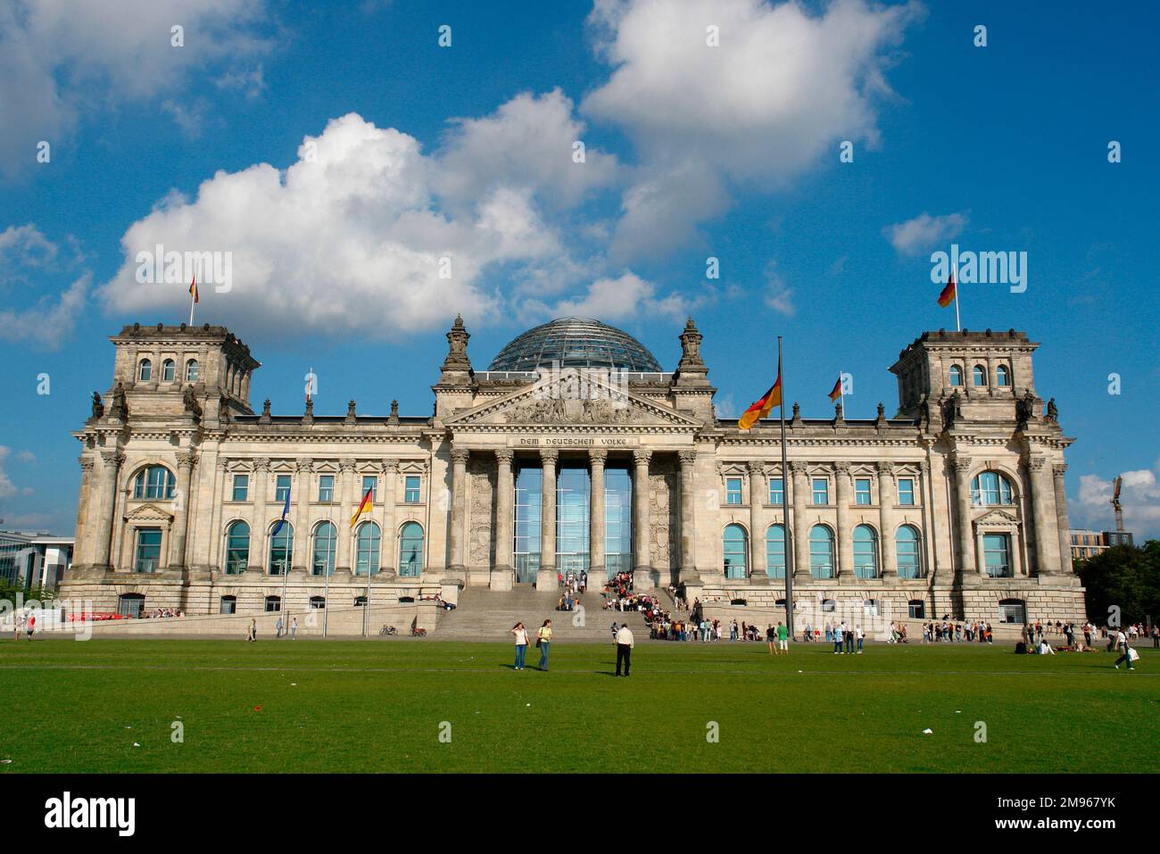 View of the front facade of the Reichstag building in Berlin, Germany.  The building opened in 1894 to house the German parliament. It was severely damaged by fire in 1933, and its reconstruction was not completed until 1999. The dedication, 'Dem Deutschen Volke', 'For the German People', is inscribed on the architrave. Stock Photo