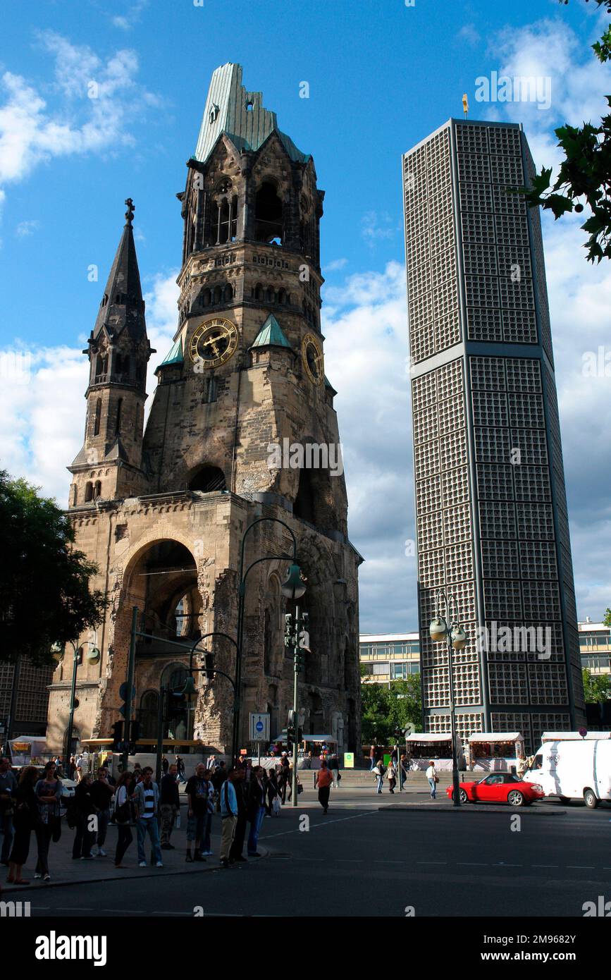 The Protestant Kaiser Wilhelm Memorial Church (Kaiser-Wilhelm-Gedachtniskirche) on the Kurfurstendamm in Berlin, Germany.  It was badly damaged in a bombing raid in 1943.  The present building, consisting of a church with an attached foyer and a separate belfry with an attached chapel, was built between 1959 and 1963.  The damaged spire of the old church has been retained and the ground floor has been turned into a memorial hall. Stock Photo
