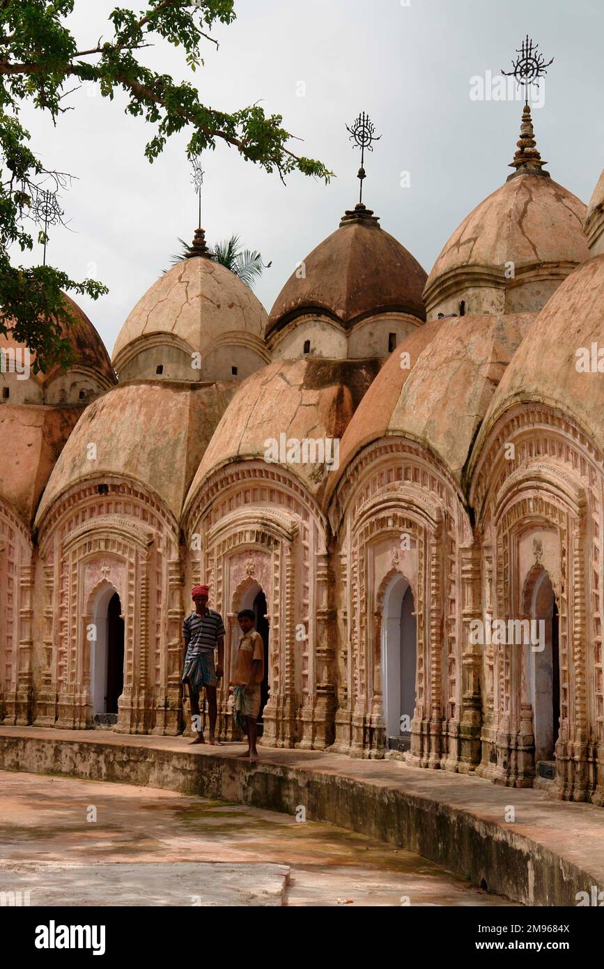 Part of a circle of Shiva (Siva) Temples in Kalna, known as the Temple City, in West Bengal, India. The Nava Kailash or 108 Shiv Mandirs was built in 1809. The temples are constructed in two circles: one of 74 temples, the other of 34. The former has white marble and black stone shivlingas, while the latter has just white marble ones. All the shivlingas can be seen from the centre of the temple complex. Stock Photo