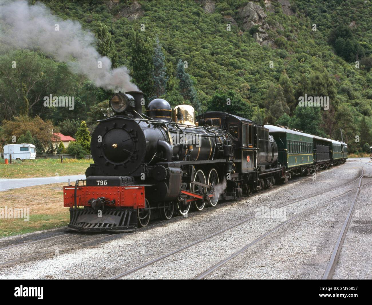 A steam train, the Kingston Flyer, at Kingston, South Island, New Zealand.  Kingston is a small town at the southernmost end of Lake Wakatipu.  The Kingston Flyer historic railway service is closely associated with the town.  It operates over a 14 kilometre long preserved section of the former Kingston Branch, which provided a rail link to Kingston for over a century, opening in 1878 and closing in 1979.  In its heyday this line was considered to be one of the most important in New Zealand. Stock Photo