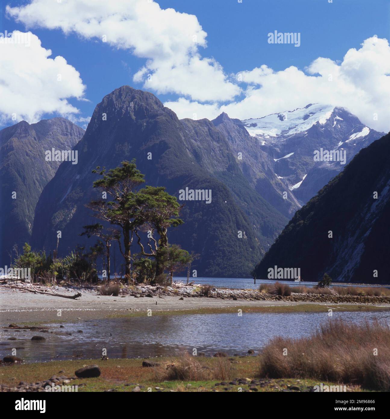 View of Milford Sound with mountains in the background, South Island, New Zealand.  Milford Sound is a fjord in the south west of the Island, within Fiordland National Park and the Te Wahipounamu World Heritage site. Stock Photo