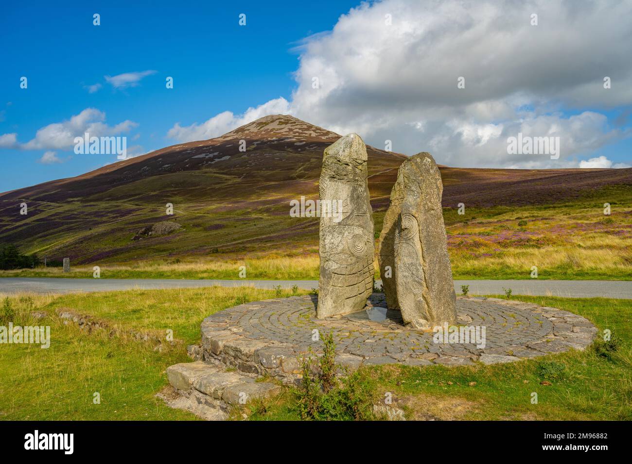 Modern carved standing stones near Nant Gwrtheyrn on the Llyn Peninsula in Gwynedd North Wales with Yr Eifl behind. Stock Photo