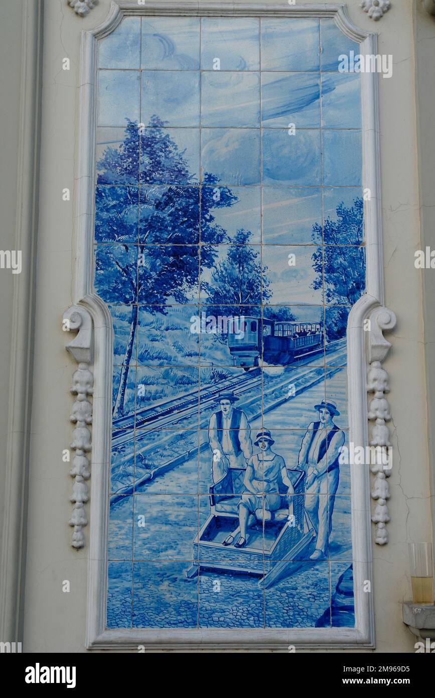 A picture on blue tiles outside the former Ritz Cafe, in the Avenida Arriaga in Funchal, Madeira, Portugal.  This type of traditional design, on blue and white tin-glazed ceramic tiles, is known in Spain and Portugal as azulejo or azulejos. Stock Photo