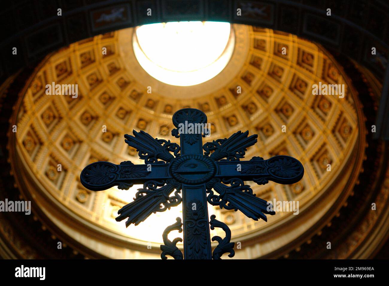 View of an ornate cross with the cupola above it, in the Basilica di San Giovanni in Laterano (Basilica of St John Lateran) in Rome, Italy.  This cathedral is the official ecclesiastical seat of the Bishop of Rome, ie the Pope. Stock Photo