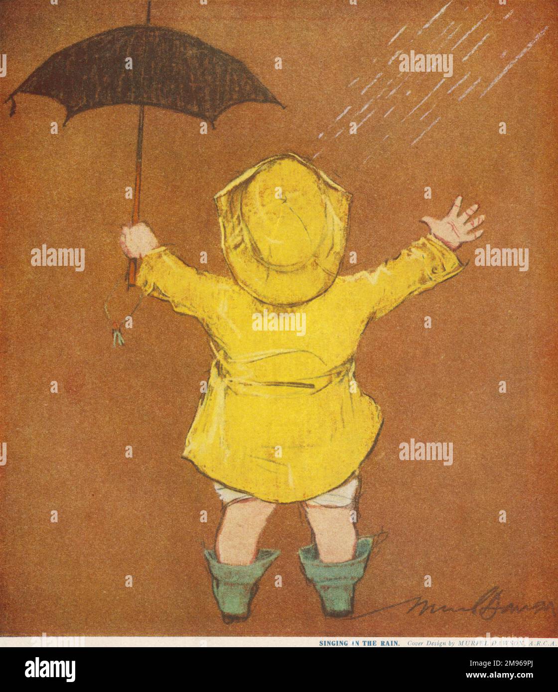 A small child wearing a classic yellow raincoat and sou'wester, holds a miniature umbrella and appears to be enjoying the rain. Stock Photo