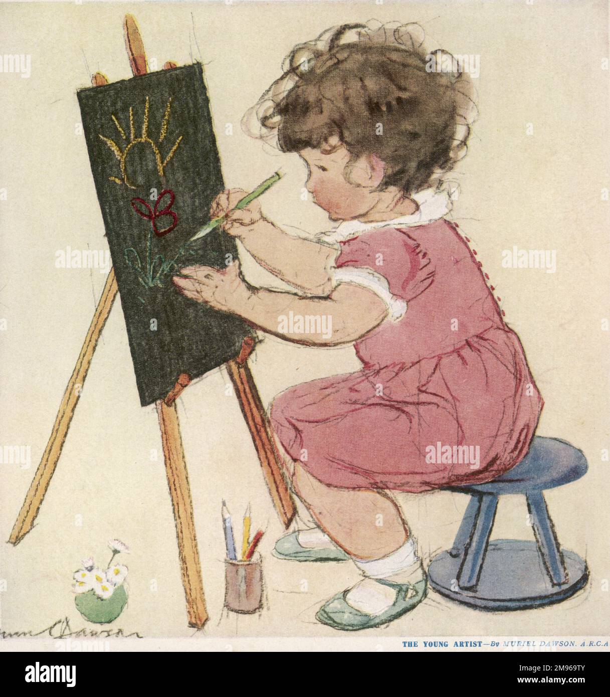 A little girl with brown curly hair, wearing a pink dress occupies herself drawing a sweet picture while sat at an easel. Stock Photo