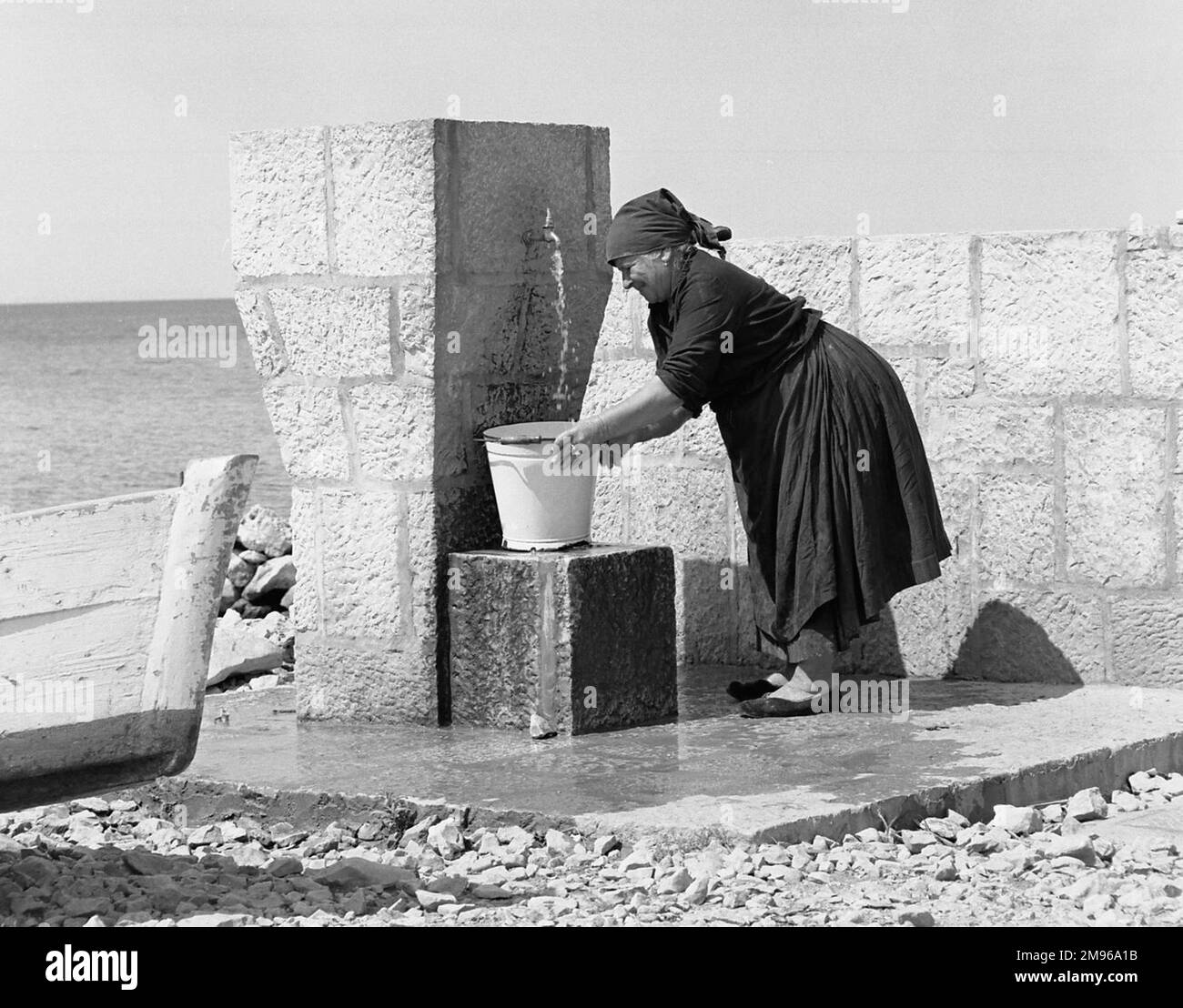 Filling water bucket Black and White Stock Photos & Images Alamy