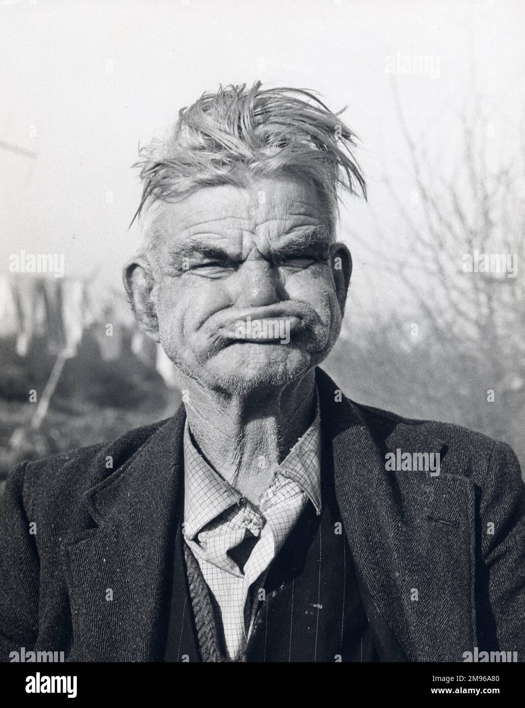 A gipsy man pulling a 'gurning face', at an encampment in Lewes, Sussex. Stock Photo