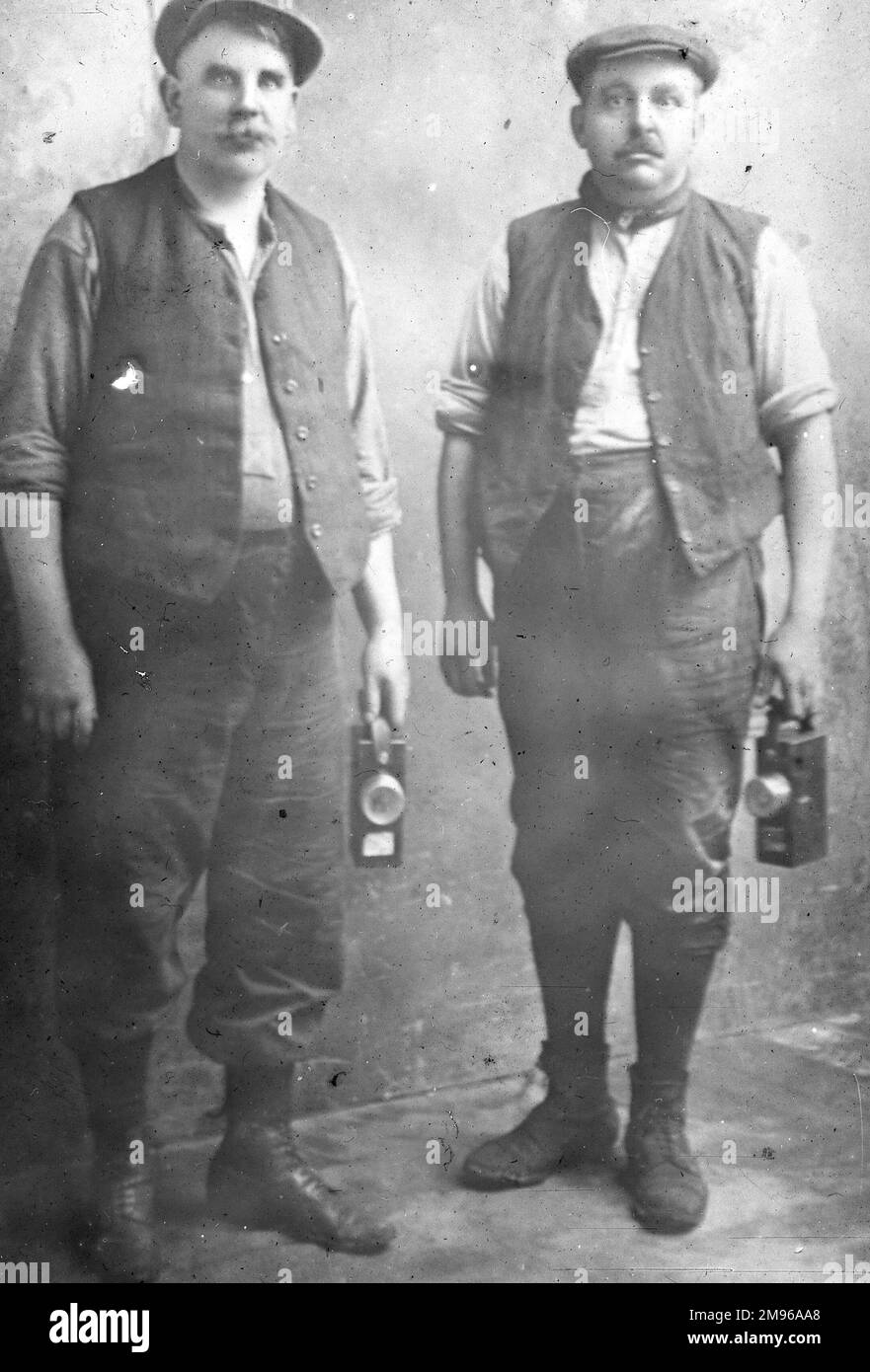 Two middle aged miners with their lamps, at a colliery in South Wales. Stock Photo
